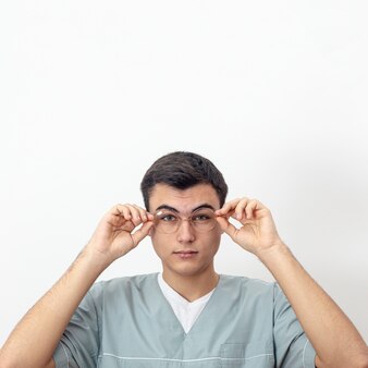 front-view-of-eye-specialist-posing-with-glasses-and-copy-space_23-2148429589